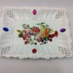 It looks like you're describing a plastic serving tray that features a jeweled or printed design. The tray is rectangular in shape and measures 23 x 17 cm. It is available in...