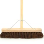 The 18" Hard Bassine Garden Wooden Broom Brush, model B18HA, is a sturdy garden tool designed for outdoor cleaning tasks. It features a 18-inch wide brush head made from bassine...