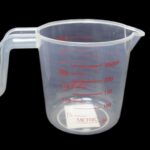 This appears to be a description of a household item, specifically a small plastic measuring jug with a capacity of 250ml. The details suggest it is designed for metric...