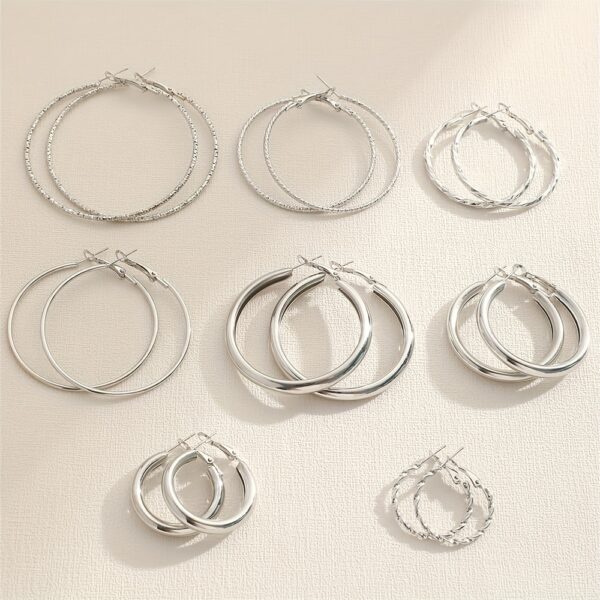 A Set Of 8 Pairs Of Simple And Stylish Twisted Wave Sparkling Earrings In Golden And Silvery Colors. - Image 9